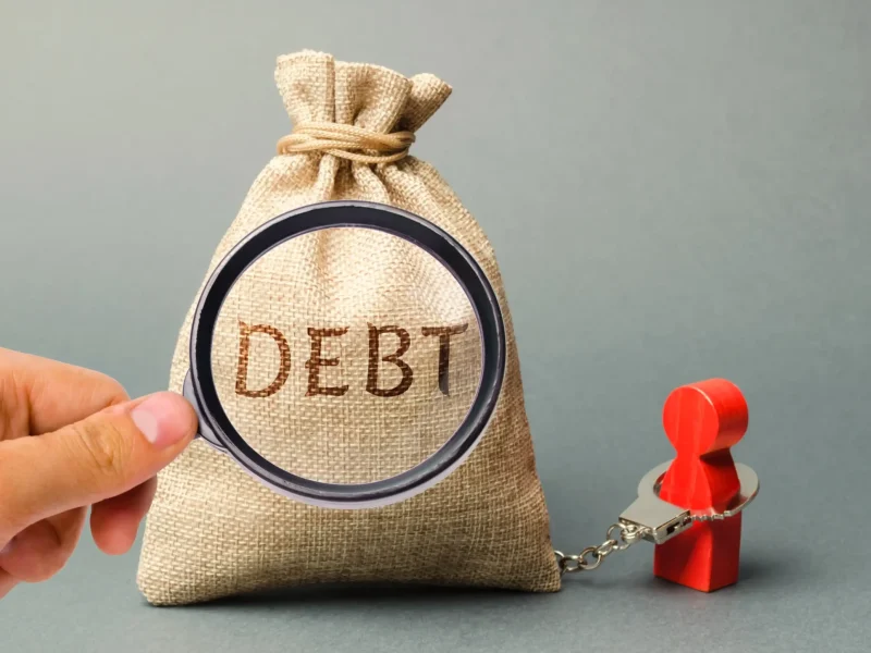 magnifying-glass-is-looking-money-bag-with-word-debt-borrower_2_11zon
